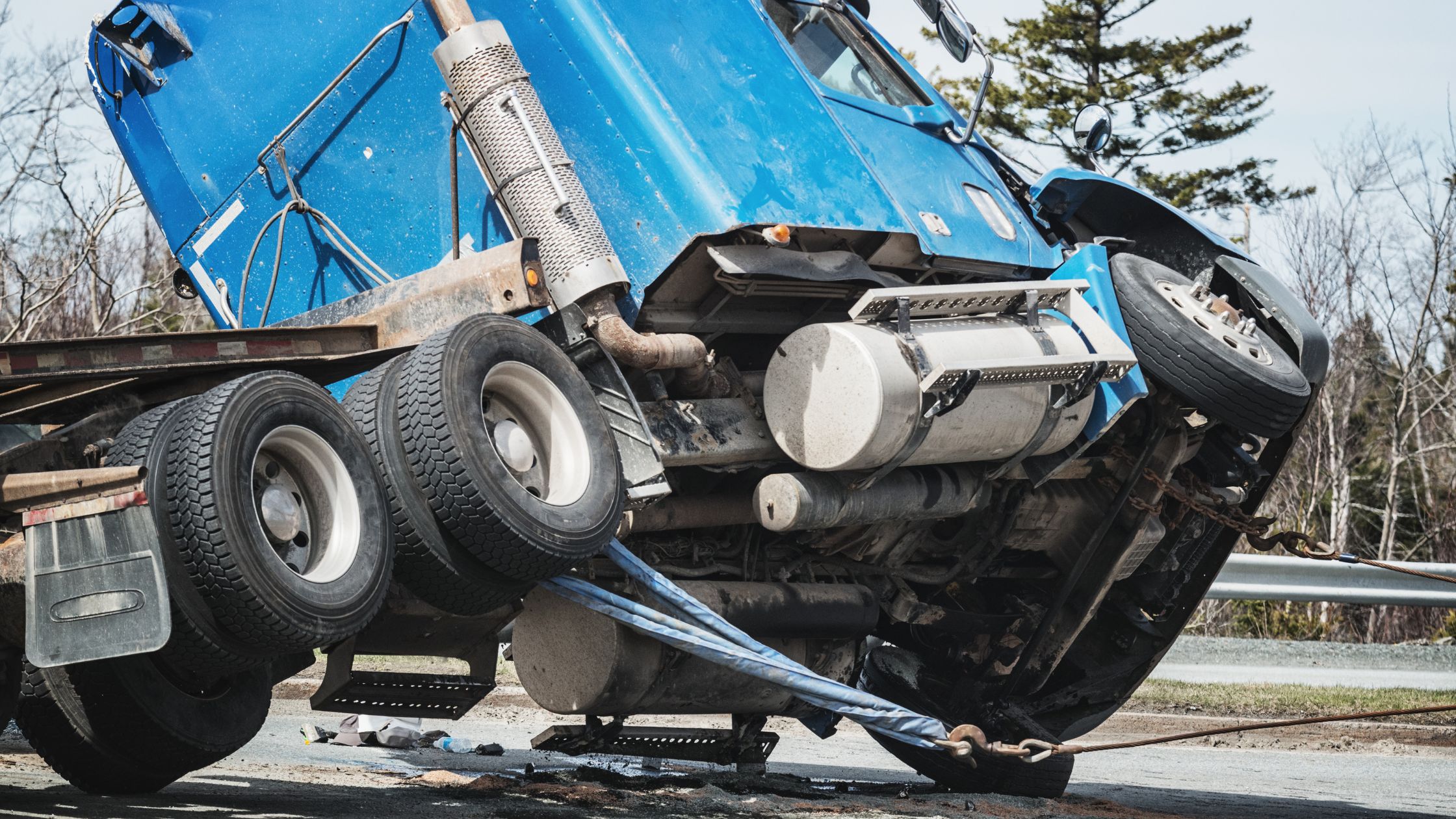 Overturned blue truck after an accident, depicting the type of incident that would require an Alamo Heights truck accident lawyer's expertise.